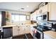 Bright kitchen with white cabinets, stainless steel appliances, and a functional layout at 9267 Welby Rd Ter, Denver, CO 80229