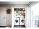 Convenient laundry room featuring modern washer and dryer, efficient shelving at 9267 Welby Rd Ter, Denver, CO 80229