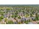 Aerial view highlighting property location within a community with houses and tree-lined streets at 4857 Tarcoola Ln, Highlands Ranch, CO 80130