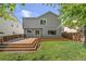 Large deck leads to the grassy lawn in this home's backyard at 4857 Tarcoola Ln, Highlands Ranch, CO 80130