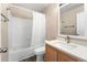 Bright bathroom featuring tub/shower, wood cabinet vanity, and neutral wall paint at 4857 Tarcoola Ln, Highlands Ranch, CO 80130