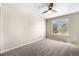 Bedroom with ceiling fan, large window, and neutral paint at 4857 Tarcoola Ln, Highlands Ranch, CO 80130