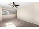Bedroom with neutral carpet, partial wall, and ceiling fan at 4857 Tarcoola Ln, Highlands Ranch, CO 80130