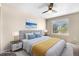 Staged bedroom with ceiling fan, large window, and neutral paint at 4857 Tarcoola Ln, Highlands Ranch, CO 80130
