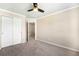 Bedroom with closet, ceiling fan, carpet, and neutral paint at 4857 Tarcoola Ln, Highlands Ranch, CO 80130