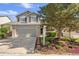 Charming two-story house with a two-car garage, brick accents, and well-manicured landscaping at 4857 Tarcoola Ln, Highlands Ranch, CO 80130