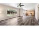 Spacious living room open to dining and kitchen, featuring backyard view and wood-look flooring at 4857 Tarcoola Ln, Highlands Ranch, CO 80130
