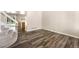 Open living room with wood-look flooring, stairs and access to dining at 4857 Tarcoola Ln, Highlands Ranch, CO 80130