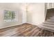 Open living room features wood-look floors, high ceiling, and staircase at 4857 Tarcoola Ln, Highlands Ranch, CO 80130