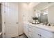 Bright bathroom with dual sinks, white cabinetry, modern fixtures, and a large mirror over the vanity at 515 176Th Ave, Broomfield, CO 80023