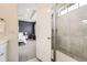 A peek into a stylish main bedroom from the ensuite bathroom with a glass enclosed walk-in shower at 515 176Th Ave, Broomfield, CO 80023