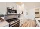Close up of the kitchen with stainless steel appliances, grey subway tiles, and hardwood flooring at 515 176Th Ave, Broomfield, CO 80023