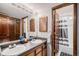 Bathroom featuring double sinks with wood cabinets and a tiled shower/tub at 16724 E Hialeah Ave, Centennial, CO 80015