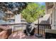 Outdoor deck with a grill, surrounded by mature trees and lush greenery at 16724 E Hialeah Ave, Centennial, CO 80015