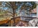 Outdoor deck with a grill, surrounded by mature trees for privacy and shade at 16724 E Hialeah Ave, Centennial, CO 80015