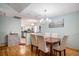 Dining room flowing into kitchen, featuring hardwood floors and plenty of light at 16724 E Hialeah Ave, Centennial, CO 80015