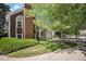 Charming home featuring a brick chimney, lush landscaping, and a well-maintained lawn at 16724 E Hialeah Ave, Centennial, CO 80015