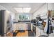 Updated kitchen featuring stainless steel appliances and a window overlooking the backyard at 16724 E Hialeah Ave, Centennial, CO 80015