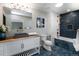 Stylish bathroom boasts modern vanity, vessel sink, mosaic tile, and soaking tub with shower at 6368 S Emporia Cir, Englewood, CO 80111