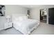 Spacious bedroom featuring neutral tones, comfortable bedding, and a glimpse into an ensuite bathroom at 6368 S Emporia Cir, Englewood, CO 80111