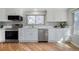 Well-lit kitchen featuring white cabinets, stainless steel appliances, and marble countertops for a sleek design at 6368 S Emporia Cir, Englewood, CO 80111