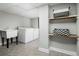 Functional laundry room with washer, dryer, utility sink, and open shelving for storage at 6368 S Emporia Cir, Englewood, CO 80111