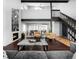 A modern living room with a fireplace and striking staircase design at 6368 S Emporia Cir, Englewood, CO 80111