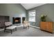 Comfortable sitting room with fireplace, built-in shelving and views from the large window at 6368 S Emporia Cir, Englewood, CO 80111