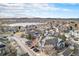 Aerial view of a residential neighborhood near a lake with mountains in the background at 12943 N Lafayette St # H, Thornton, CO 80241