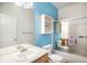 Bright bathroom features vanity with ample counter space and sliding glass doors on tub/shower at 12943 N Lafayette St # H, Thornton, CO 80241