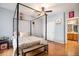 Light-filled bedroom with wood floors and a view of the en suite bathroom at 12943 N Lafayette St # H, Thornton, CO 80241