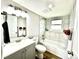 Modern bathroom features tiled walls, new fixtures, and a bathtub with shower, offering a sleek design at 8820 Cody St, Broomfield, CO 80021