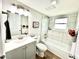 Tastefully remodeled bathroom features a shower-tub, white vanity and a framed mirror at 8820 Cody St, Broomfield, CO 80021