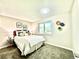 Bright bedroom features a comfortable bed with floral wall decor, enhancing the room's cozy appeal at 8820 Cody St, Broomfield, CO 80021