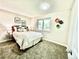 Cozy bedroom with floral wall art, plush carpeting, and a sunny window, creating a relaxing atmosphere at 8820 Cody St, Broomfield, CO 80021
