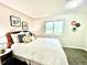 Inviting bedroom with a decorative headboard, floral art, and a window view, creating a peaceful retreat at 8820 Cody St, Broomfield, CO 80021