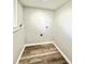 Convenient laundry room with wood-look flooring and utility connections, ready for appliance installation at 8820 Cody St, Broomfield, CO 80021