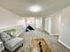 Spacious carpeted living room with white walls, ample light, and bonus area for the to play at 8820 Cody St, Broomfield, CO 80021
