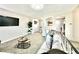 Bright living room with neutral tones, TV, modern furnishings, and access to other living areas at 8820 Cody St, Broomfield, CO 80021
