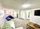Spacious carpeted living room with white walls, ample light, and bonus area for the to play at 8820 Cody St, Broomfield, CO 80021