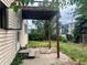 Backyard with overgrown yard, patio, and covered porch at 1413 Centennial Dr, Longmont, CO 80501