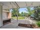 Covered backyard patio looks out onto a large lawn, storage shed, garden, and playset at 1370 S Hudson St, Denver, CO 80222