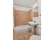 Bathroom featuring tiled shower/tub combo, pedestal sink, and neutral decor at 1370 S Hudson St, Denver, CO 80222
