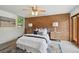 Charming bedroom featuring a brick wall, ceiling fan, bedside tables, and a plush rug at 1370 S Hudson St, Denver, CO 80222