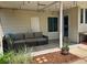 Inviting covered patio features comfortable outdoor seating, decorative lighting, and access to the home at 1370 S Hudson St, Denver, CO 80222
