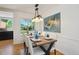 Bright dining room featuring a modern table and chairs, with views of the backyard at 1370 S Hudson St, Denver, CO 80222