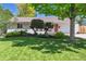 Charming home with a well-maintained lawn, colorful landscaping, and a red front door at 1370 S Hudson St, Denver, CO 80222