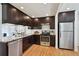 Modern kitchen with stainless steel appliances, granite countertops, and ample cabinet space at 1370 S Hudson St, Denver, CO 80222