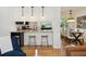 Eat-in kitchen bar with stylish stools and an open view into the dining area at 1370 S Hudson St, Denver, CO 80222
