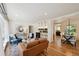 Open-concept living area with hardwood floors connecting the living and dining spaces at 1370 S Hudson St, Denver, CO 80222